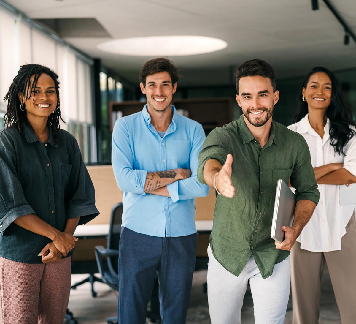 Smiling office team welcoming a new employee as part of a structured onboarding process